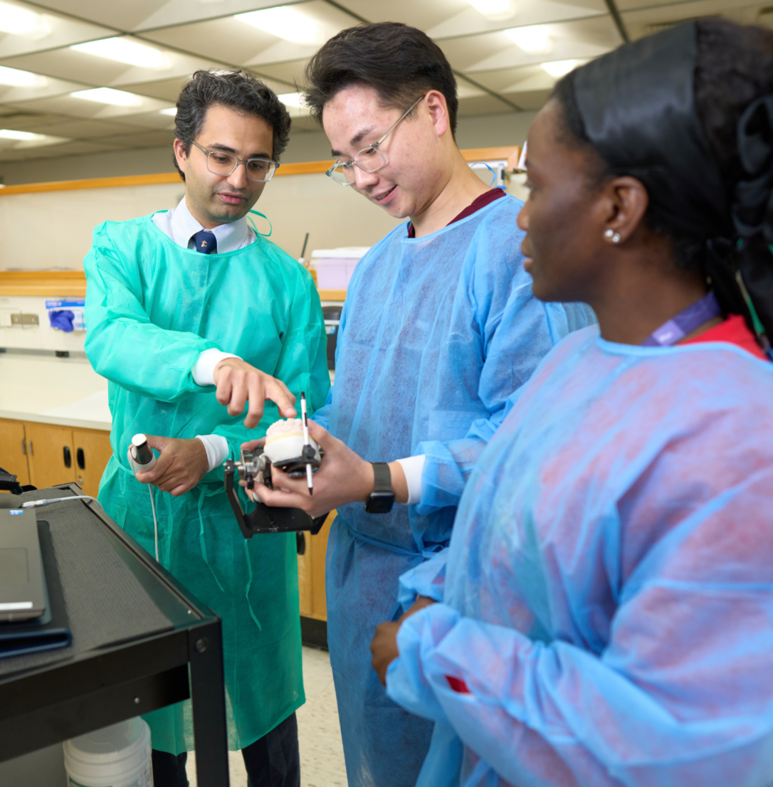 Prosthodontics faculty member in conversation with two residents