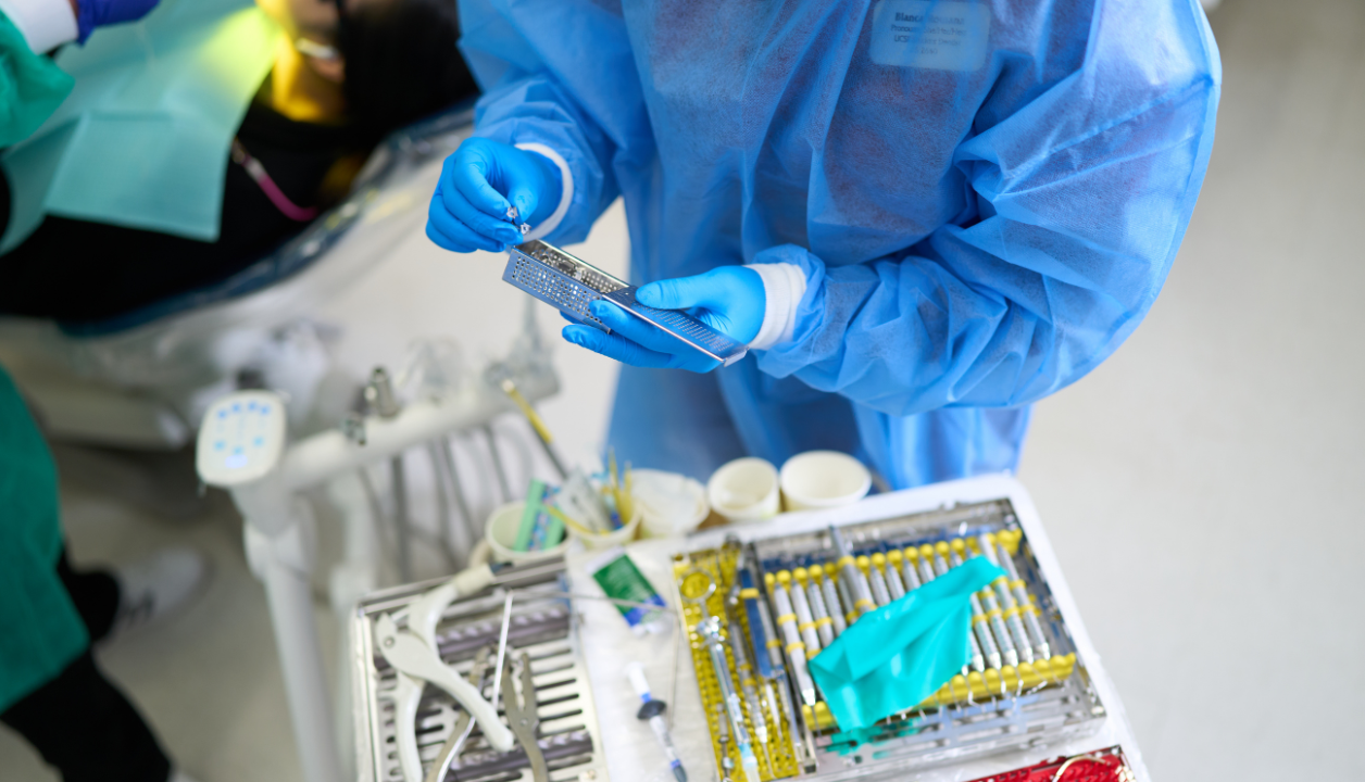 DDS student holding dental instruments
