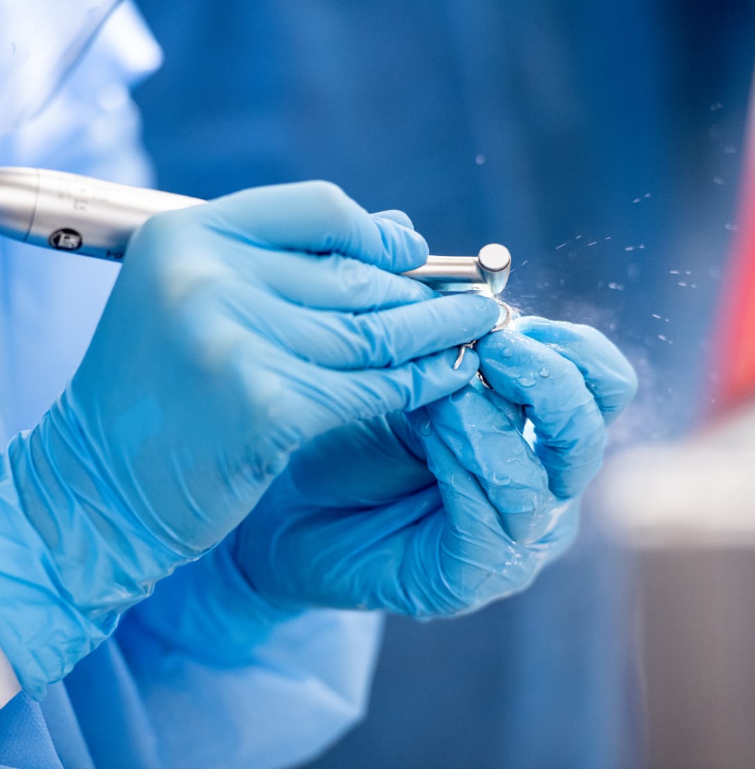 Dental handpiece in use with water spray.
